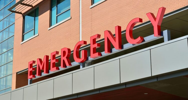 a-red-signage-that-reads-emergency-in-bold-letters